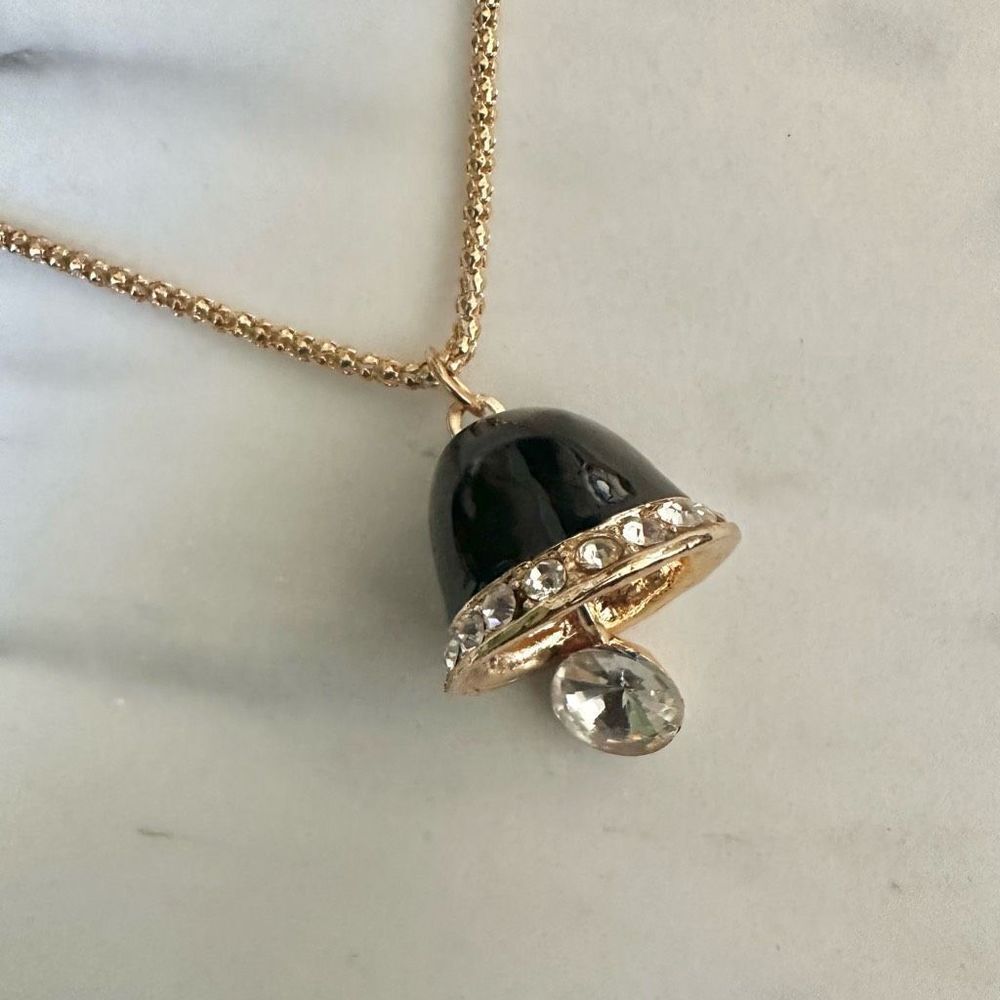 Gold tone black bell pendant necklace